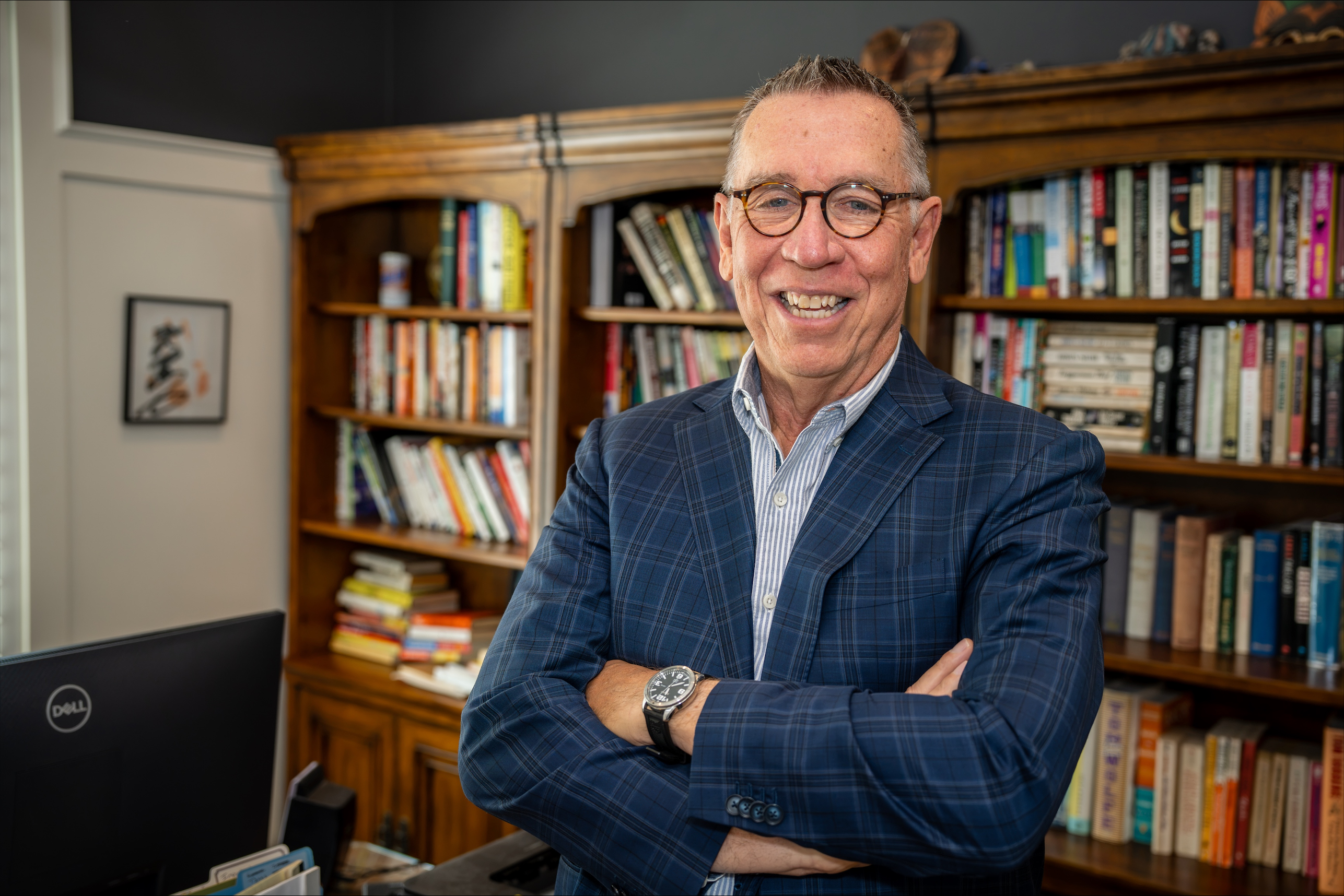 Andrew Urich smiling in his office